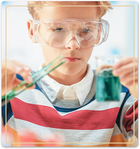 boy holding test tubes